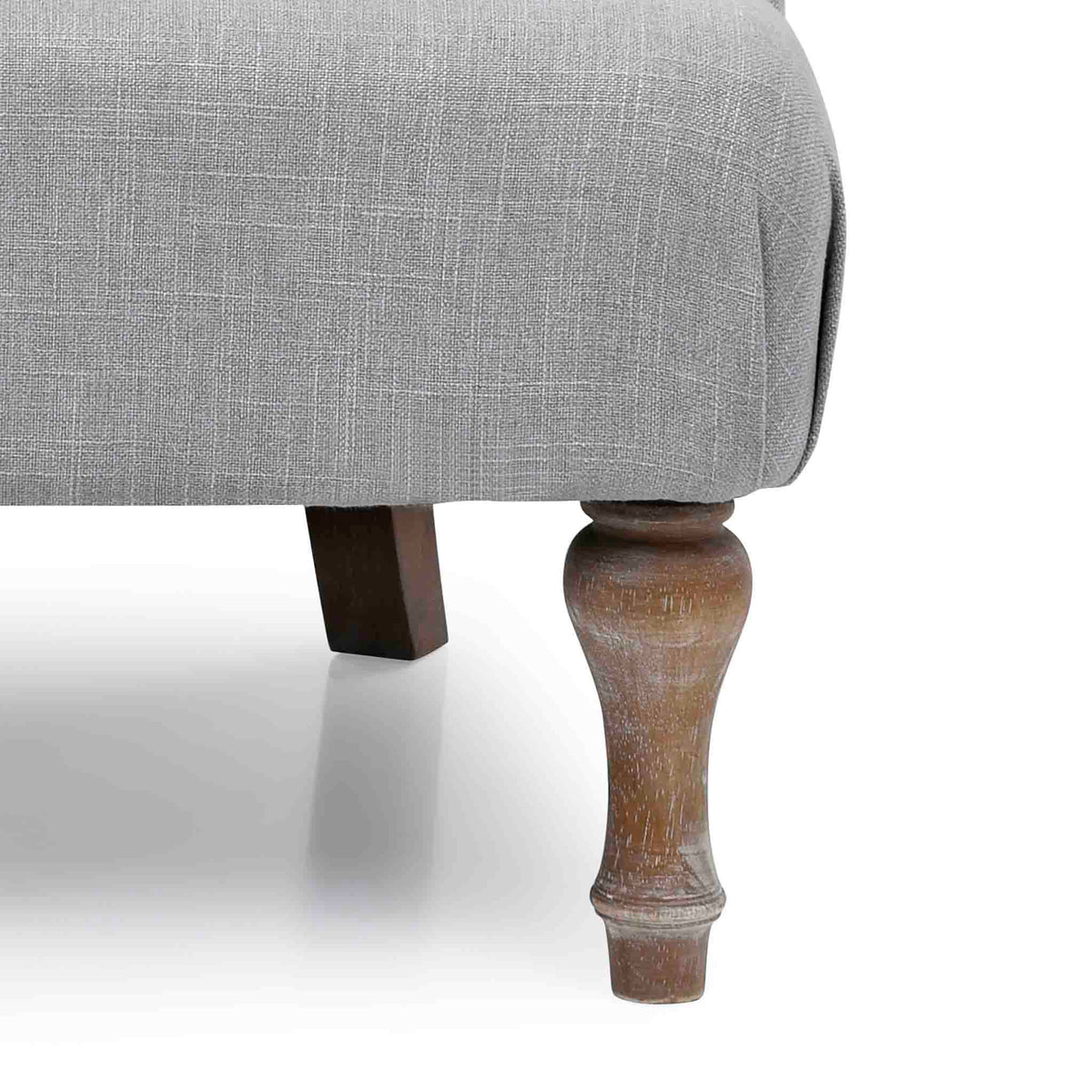 close up of the distressed antique turned wooden legs on the Grey Linen Fabric Bianca Armchair
