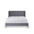 A grey upholstered bed with a tufted headboard is stationary against a white background. A plush white mattress sits atop the frame.