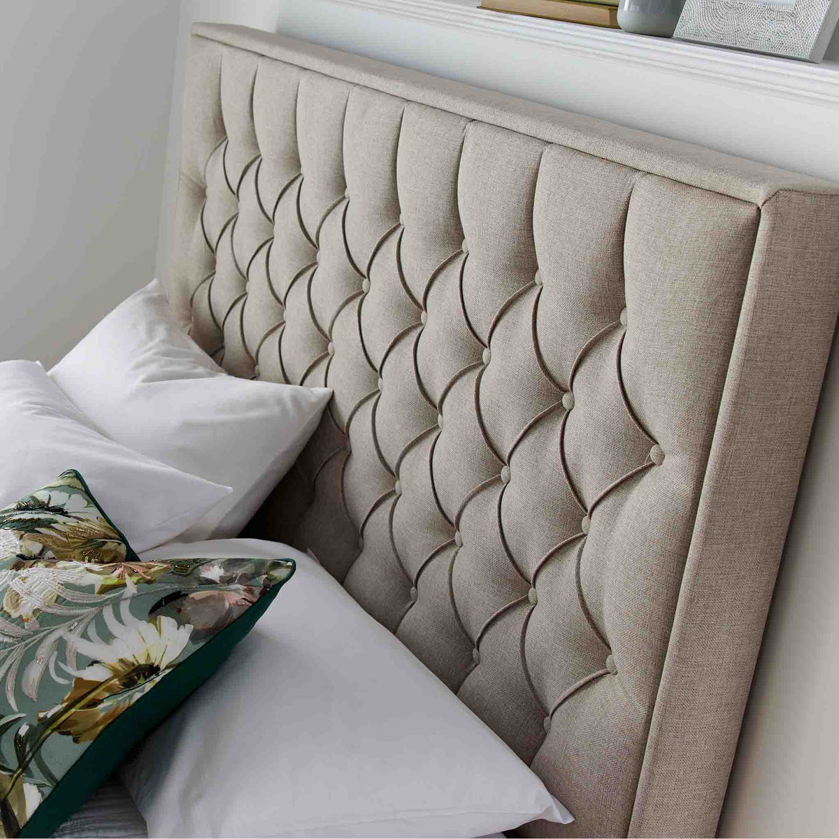 close up of button tufted headboard on the Sutton Oatmeal Upholstered Fabric Ottoman Storage Bed