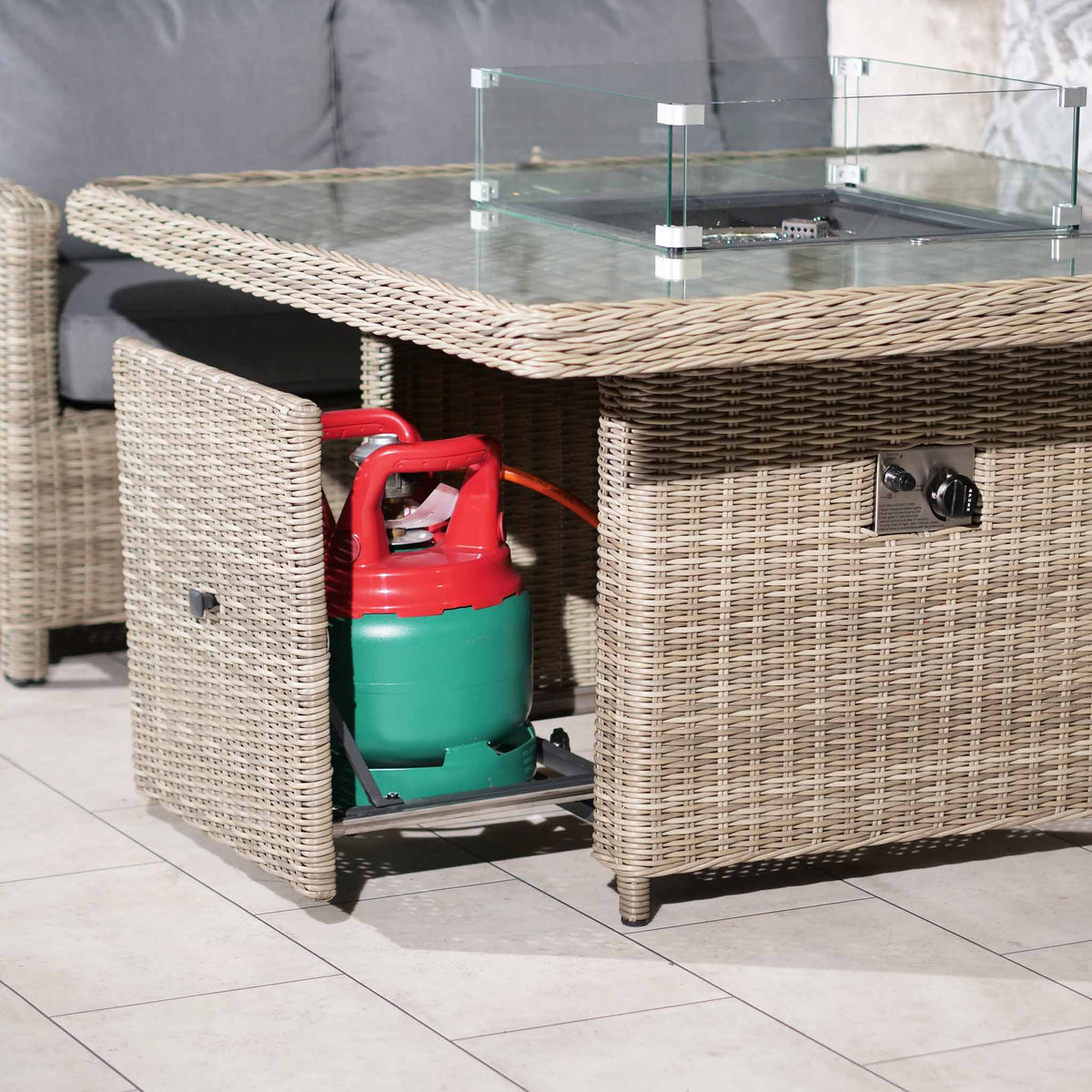 Wentworth Rattan 120cm Fire Pit Garden Dining Table & Lounge Set close up of gas cylinder storage compartment