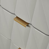 A gold-colored handle protrudes from a geometric white textured surface, suggesting a modern design element on furniture or an architectural feature.