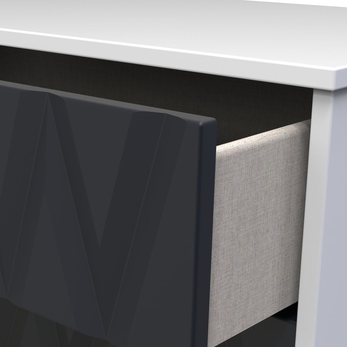 A black computer monitor sits on a white desk adjacent to a gray fabric panel partition, suggesting an office setting.