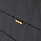 A single gold bar, subtly illuminated, protrudes from a textured, angular dark back wall with geometric patterning.
